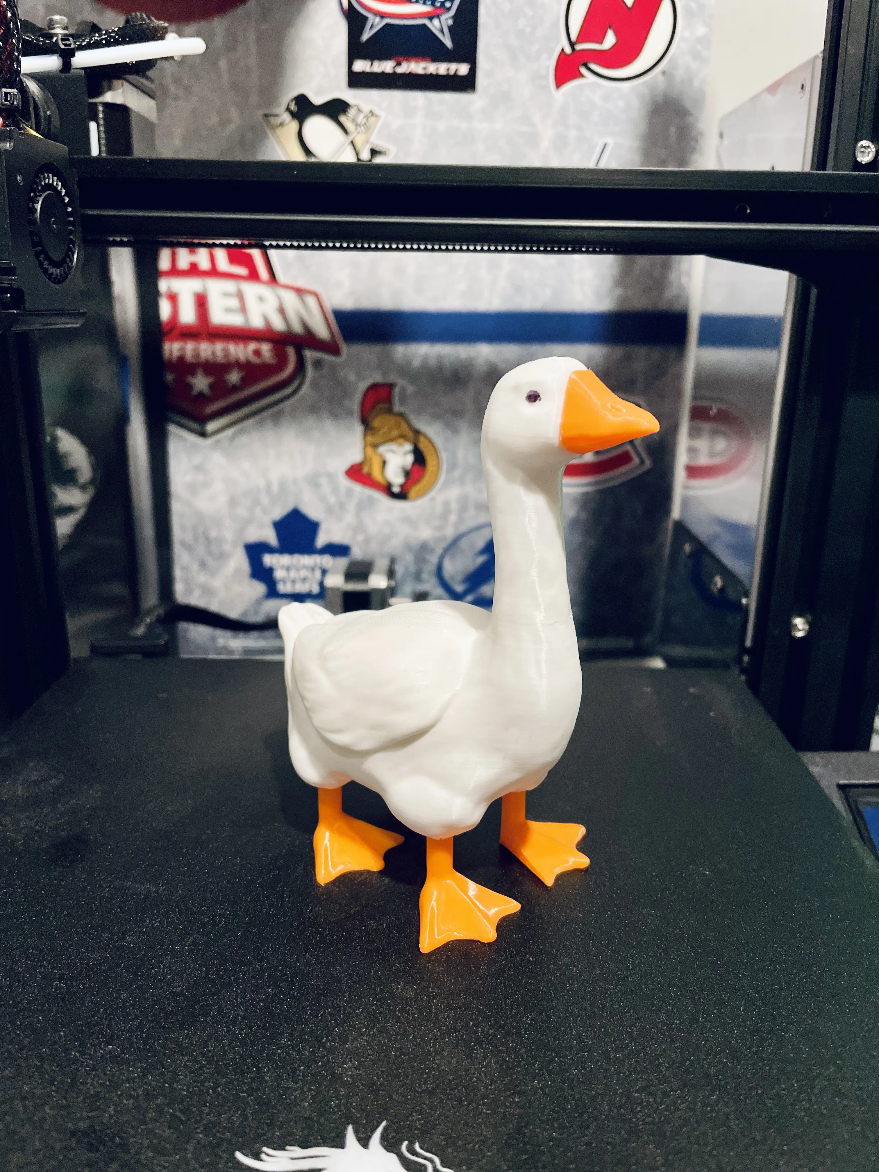 A white, 3D printed goose with 4 legs