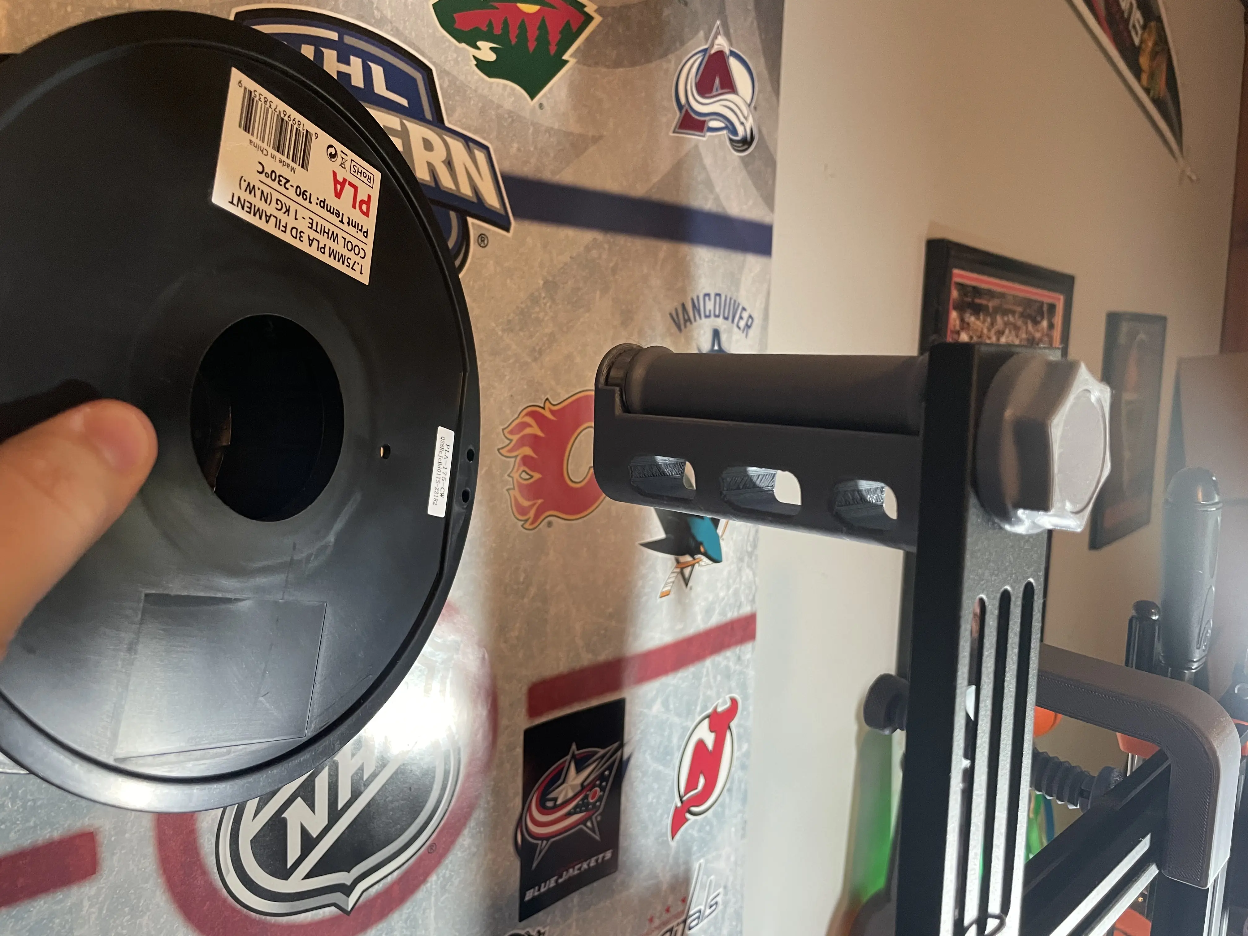 A gray, 3D printed plastic filament holder for my 3D printer.